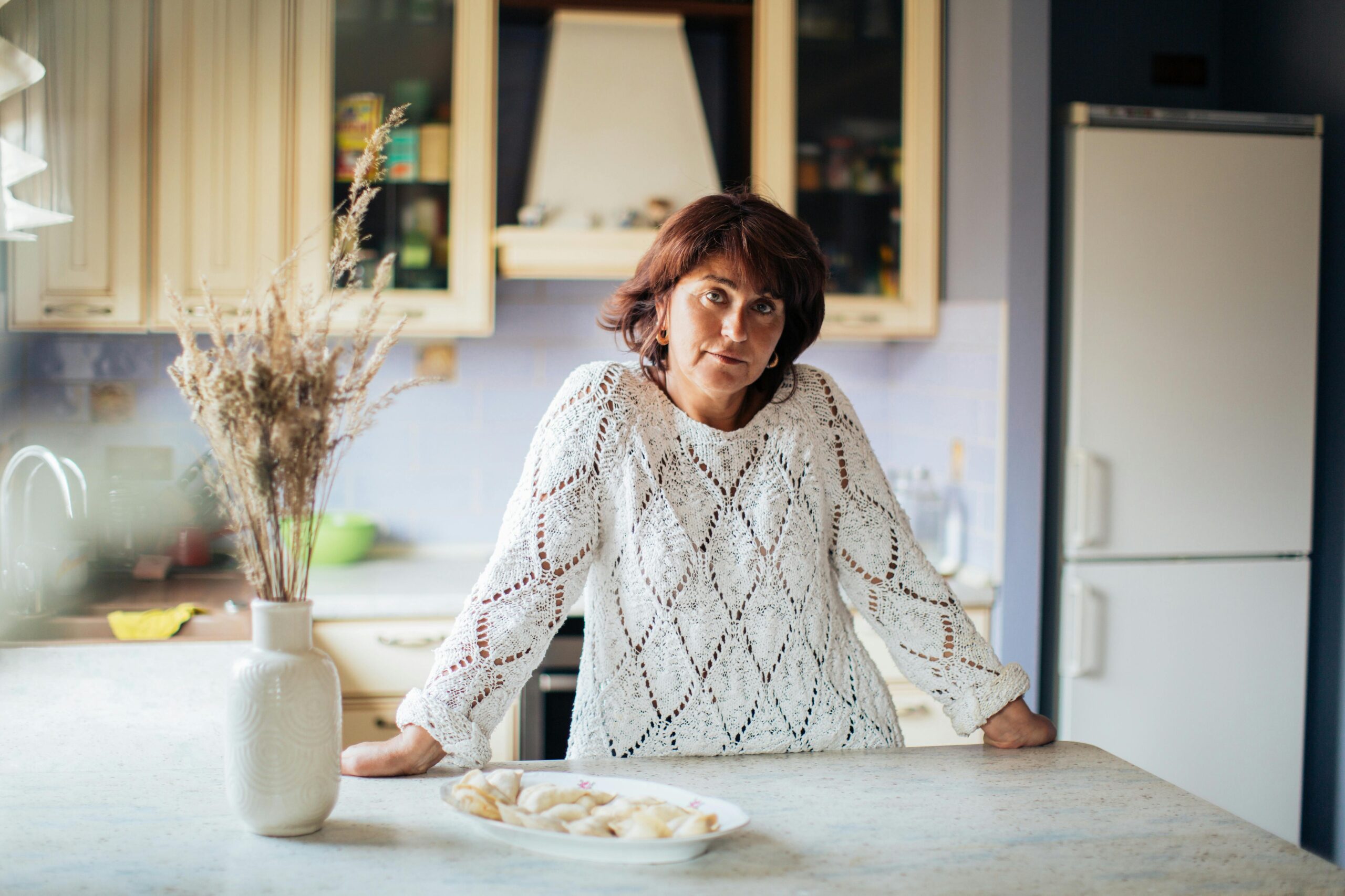 mangiare in fretta e gonfiore addominale donna seduta in cucina